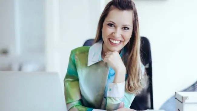 A happy woman in her office